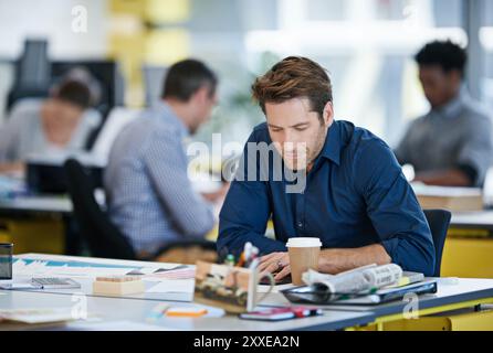 Tablet, business man and working at desk for research, reading email or check report on app at startup. Technology, creative and interior designer at Stock Photo