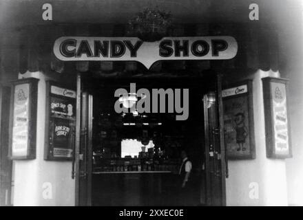 Candy Shop connected to unidentified West German cinema at the time showing DEAN MARTIN and JERRY LEWIS in THREE RING CIRCUS (1954) and LON McCALLISTER and WANDA HENDRIX in MONTANA TERRITORY (1952) in movie theatre showing English language American films for soldiers of US Army of Occupation circa mid-1955 Stock Photo