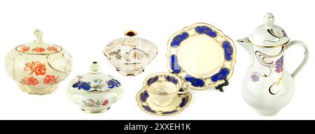 Vintage porcelain tableware: coffeepot, coffee cup with saucer and elegant candy bowl isolated on white background. Collage.Wide photo. Stock Photo