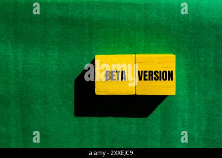 Beta version message written on yellow wooden cubes with green background. Conceptual beta version symbol. Copy space. Stock Photo