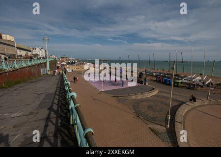 A community basketball court with players on at Brighton beach seafront England playing on a sunny evening. Stock Photo