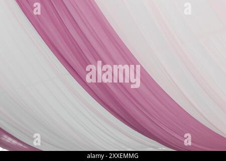 A view of a pink curtain tent fabric, as a background. Stock Photo