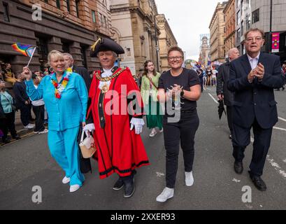 Manchester, UK. 24th Aug, 2024. Manchester dignitaries (l-R) Karen Andrews MP , Lord Mayor of Manchester, Councillor Paul Andrews, Leader of Council Bev Craig and Councillor Pat Karney take part Manchester pride parade Palestinian protesters failed to prevent Pride Parade taking place after they blocked road on Peter Street by laying in road. They were objecting against Booking.com who also carry adverts for properties in Israel. The police moved in and cleared the protest allowing the protest to proceed. Some individuals in the parade where carrying Palestinian flags.Manchester Pride 2024 . C Stock Photo