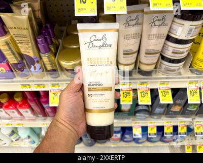 Los Angeles, California, United States - 04-14-2024: A view of a hand holding a container of Carol's Daughter shampoo, at the store. Stock Photo