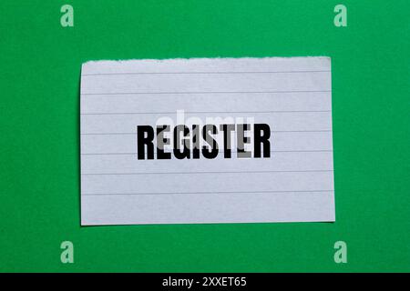 Register message written on ripped torn paper piece with green background. Conceptual register symbol. Copy space. Stock Photo