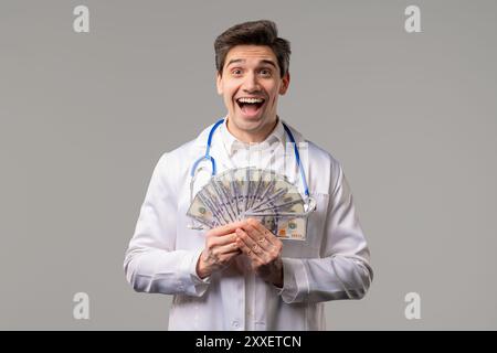 Rich Doctor Man with Usd money. Handsome Medical Health Care Worker In White Coat with salary, payment. Jackpot, win. High quality photo Stock Photo