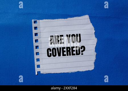 Are you covered question message written on ripped torn paper peices on ...