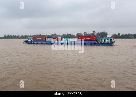 Mekong River, Vietnam/Cambodia. Aug 24,2024: Vietnamese container ship transports containers on the Asian waterway, one of Asia's biggest waterways. Maritime shipping freight transport is source of geopolitical tensions, environmental concerns & controversies as Cambodian PM plans to build Funan Techo canal (officially Tonle Bassac Navigation Road & Logistics System Project), a $1.7 billion China-backed project to connect Phnom Penh to Kampot seaport, diverting its goods for export directly to its own coast rather than via the Hanoi-controlled Mekong Delta. Credit: Kevin Izorce/Alamy Live News Stock Photo