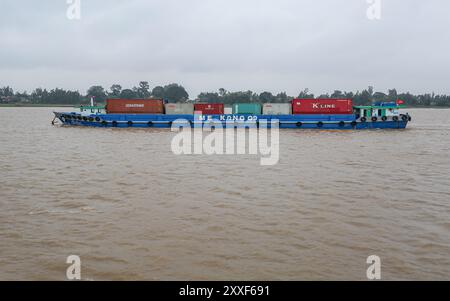 Mekong River, Vietnam/Cambodia. Aug 24,2024: Vietnamese container ship transports containers on the Asian waterway, one of Asia's biggest waterways. Maritime shipping freight transport is source of geopolitical tensions, environmental concerns & controversies as Cambodian PM plans to build Funan Techo canal (officially Tonle Bassac Navigation Road & Logistics System Project), a $1.7 billion China-backed project to connect Phnom Penh to Kampot seaport, diverting its goods for export directly to its own coast rather than via the Hanoi-controlled Mekong Delta. Credit: Kevin Izorce/Alamy Live News Stock Photo