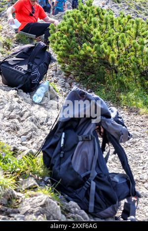 man with a bag on a mountain trail Stock Photo