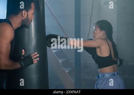 Fit and Strong Multicultural Couple Practicing Boxing Together in the Gym, Health and Unit concept Stock Photo