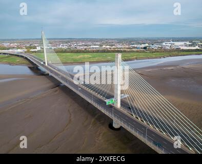 Aerial establishing view of The Mersey Gateway Bridge over the Mersey estuary, Runcorn, Cheshire, England Stock Photo