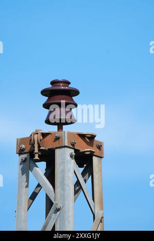 Porcelain insulator on a disused electricity pylon. Stock Photo