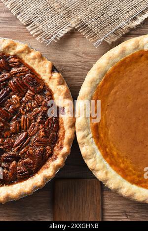 Two pies on a Thanksgiving holiday table. Pumpkin and pecan pies are traditional desserts for the American holiday. Stock Photo