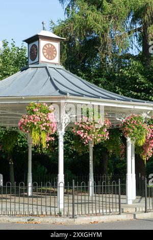 The bandstand is a historic monument in the War Memorial Park in Basingstoke. Seen here newly painted with hanging flower baskets in late summer. UK Stock Photo