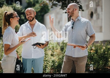 Casual business meeting outdoors with cheerful colleagues discussing new project ideas Stock Photo
