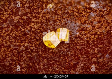 Yellow Pyromorphite on red hematite on quartz. Specimen from Clara Mine, Germany. Micro photography extreme close-up. microscope mineral crystal photo Stock Photo