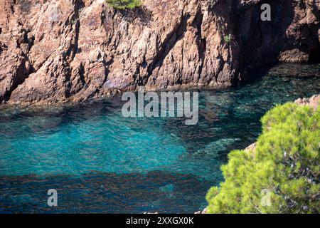 Views along Corniche d’Or or Corniche de l’Esterel beautiful coastal road, crystalline blue sea and sky combined with reddish color of Massif de l’Est Stock Photo