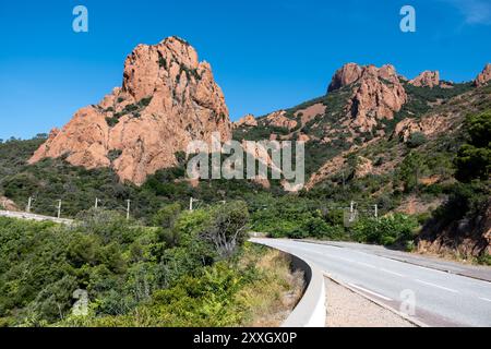 Views along Corniche d’Or or Corniche de l’Esterel beautiful coastal road, crystalline blue sea and sky combined with reddish color of Massif de l’Est Stock Photo