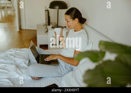 Working Remotely Create a Cozy and Inviting Home Office Setup with Fresh Coffee Stock Photo