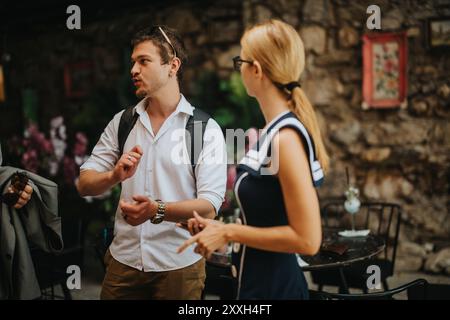 Casual conversation between colleagues in outdoor cafe setting Stock Photo
