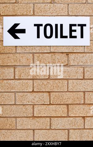 Toilet sign on a brick wall, Western Australia Stock Photo