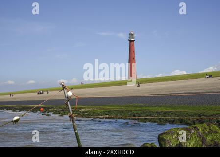 Den Helder, Netherlands. July 2022. The lighthouse of Den Helder with low tide Stock Photo