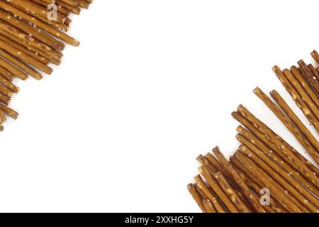 Salted pretzel sticks in two groups diagonal on a white background, copy space Stock Photo