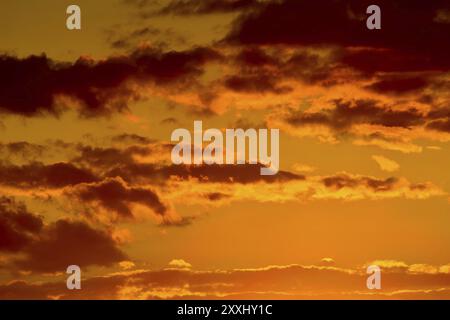 Heavenly landscape with dramatic crimson sunset clouds Stock Photo