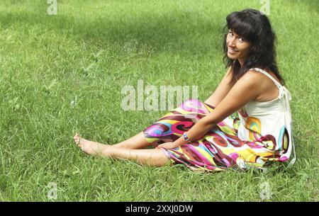 Young smiling brunette woman in summer park Stock Photo