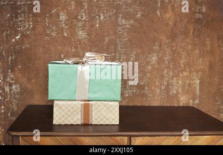 Stack of handcraft gift boxes on wooden board with a natural textured brown background Stock Photo