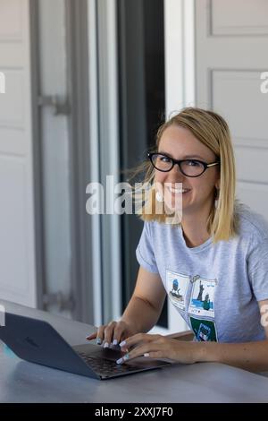young IT specialist working on laptop outdoors Stock Photo