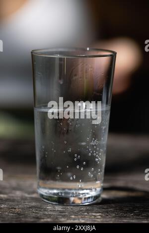 Glass of clean mineral sparkling water with ice on white background ...