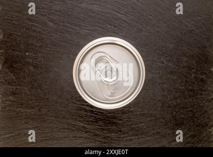 Two metal cans with drink on slate stone, macro, top view. Stock Photo