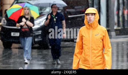 London, UK. 25th Aug, 2024. People walk in rain in London, Britain, Aug. 24, 2024. The Met Office, Britain's national meteorological service, issued a yellow alert for heavy rain across much of southeast England, as a storm hit some parts of the country Saturday. Credit: Xinhua/Alamy Live News Stock Photo