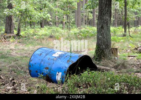 Empty blue fuel barrel in the forest. Stock Photo