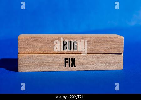 Bug fix message written on ripped torn white paper piece with yellow ...