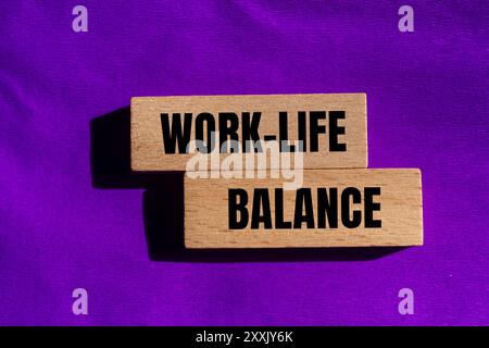 Work life balance message written on wooden blocks with purple background. Conceptual work life balance symbol. Copy space. Stock Photo