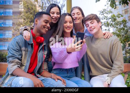 Students having fun with mobile phones creating content on social media. Stock Photo