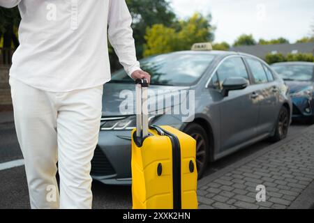 Catching a Cab. Male traveller standing near airport, waving hand, calling taxi driver, free space Stock Photo