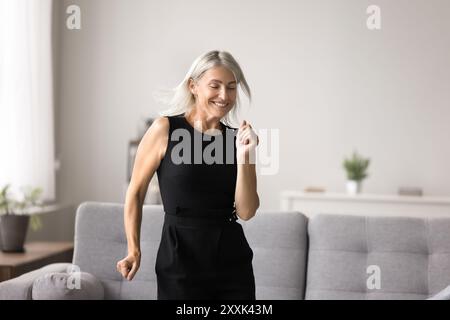 Female listen favourite music and dancing in modern living room Stock Photo