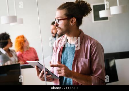 Happy software developers working on meeting, Programming advanced code artificial intelligence. Stock Photo
