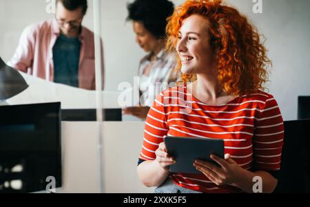 Young businesswoman leading a discussion during a meeting with her colleagues. Stock Photo