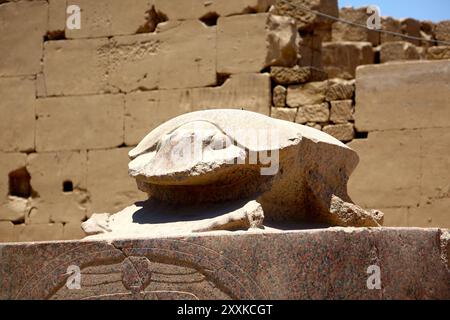 The statue of a scarab beetle sits prominently at the Karnak temple complex, symbolizing rebirth and transformation in ancient Egyptian culture. Stock Photo