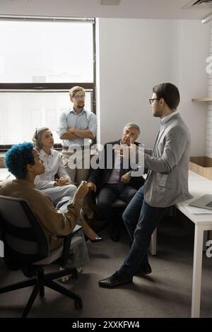 Group of professionals engaged in meeting in coworking Stock Photo