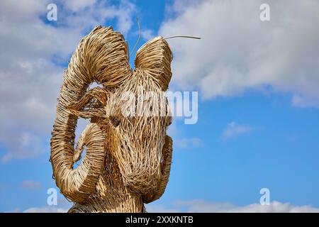 Goat woven as wicker, seen against blue sky Stock Photo