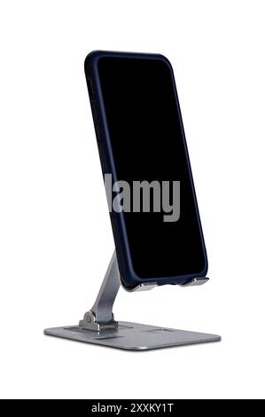 Metal alloy adjustable phone holder. View of metal alloy adjustable phone holder with smartphone isolated on white background with clipping path. Stock Photo
