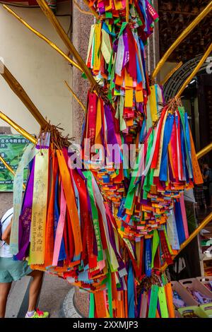 Coloured ribbons, each one representing a prayer on a prayer tree in the Kek Lok Si Buddhist Temple complex in Penang, Malaysia Stock Photo