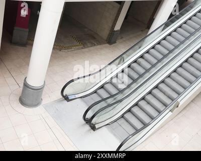 Escalators in empty retail space mall Stock Photo