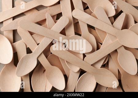 pile of disposable wooden spoons in full frame background, eco-friendly alternative single use cutlery used in parties, picnics, takeaway meals Stock Photo